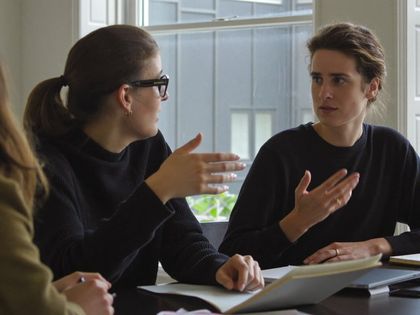 Two people in conversation during a candidate interview.