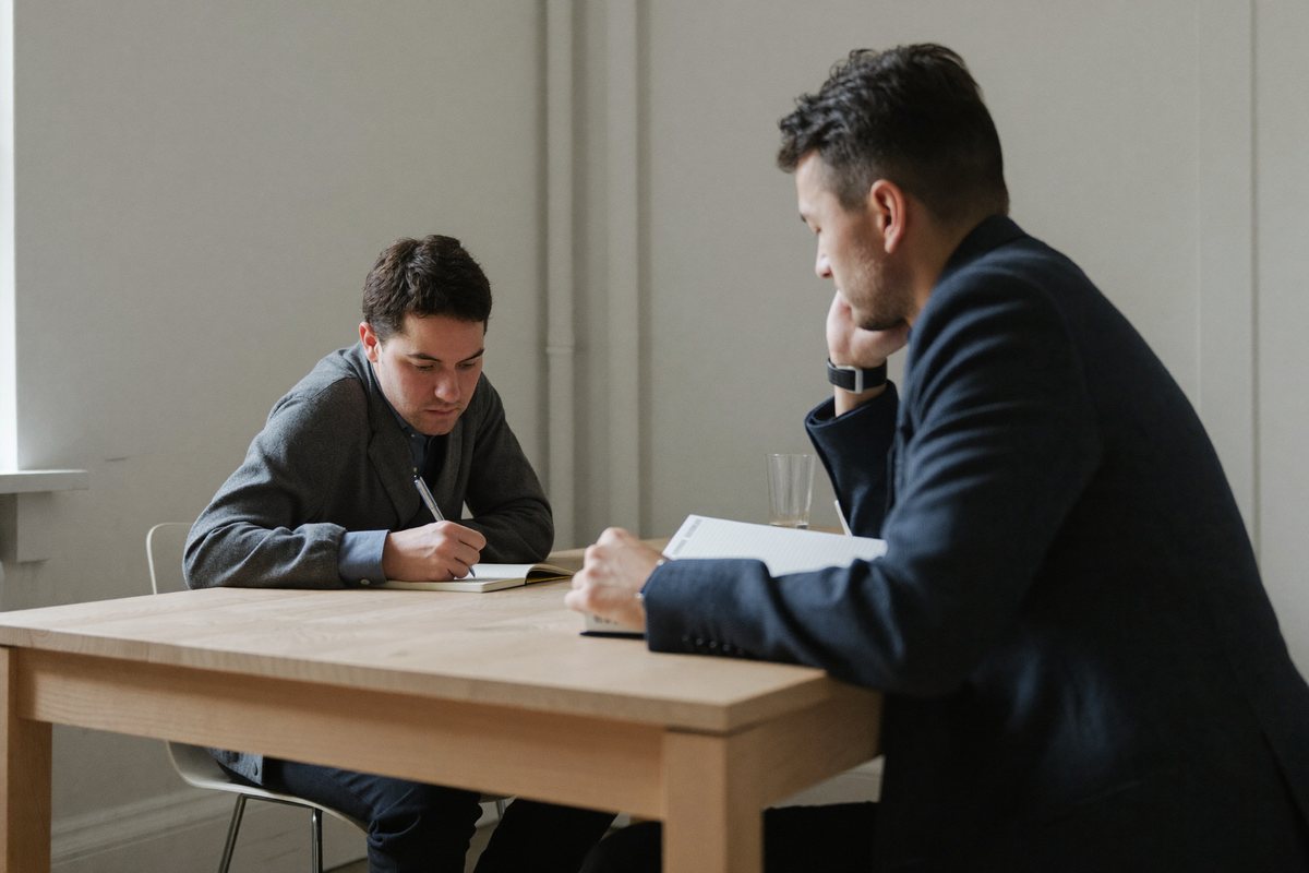 Two people in conversation during a candidate interview.
